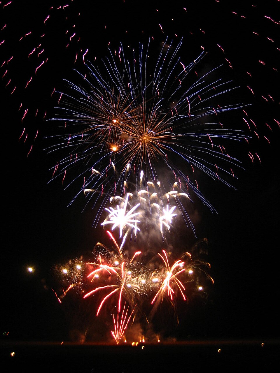 Colorful professional fireworks display finale at night